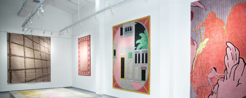 Hand‑knotted Indian rug used as wall art with intricate patterns and rich texture