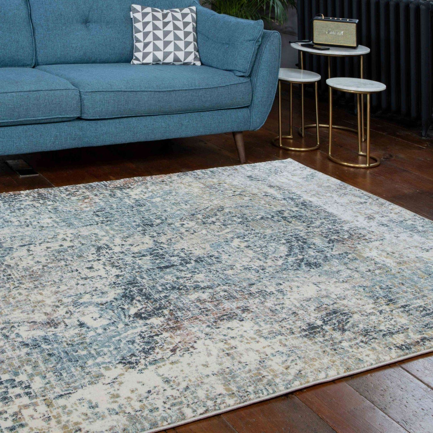 Blue distressed abstract rug in a modern bedroom.
