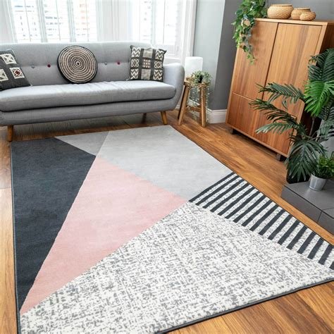 Pink and grey geometric rug in a stylish bedroom.