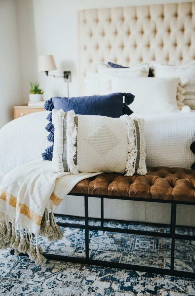 7 Smart Carpet on Carpet Bedroom Ideas for Layering Rugs 2 Decorative layered area rugs creating a distinct reading nook in a stylish bedroom.