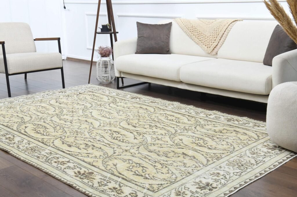 Vintage Oushak rug with distressed floral patterns and traditional craftsmanship in a modern living room
