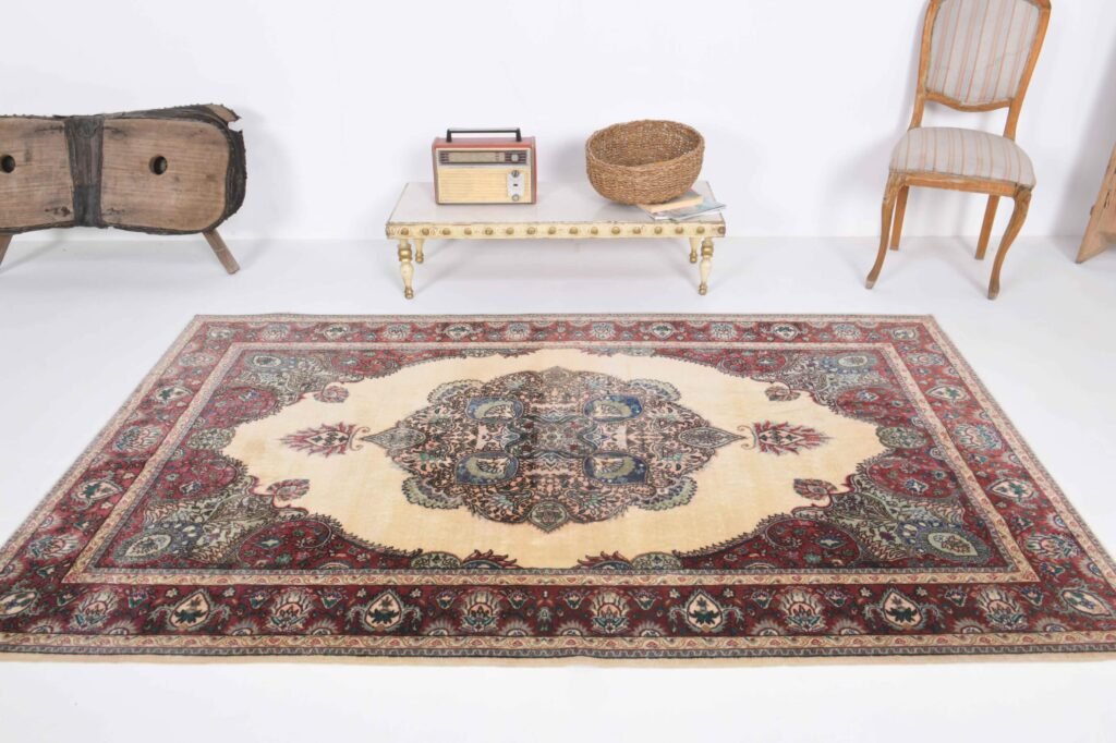 Vintage Oushak rug with intricate medallion pattern and traditional border design displayed in a stylish interior setting