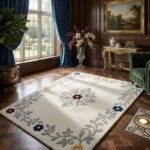 Elvarisse traditional floral rug styled in a bright living room with an ivory base and subtle navy, burgundy and mustard accents